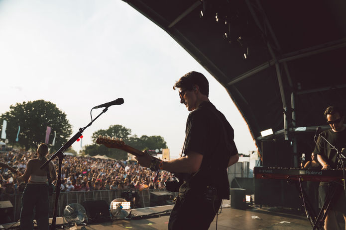 Guitarist performing live on stage at a festival